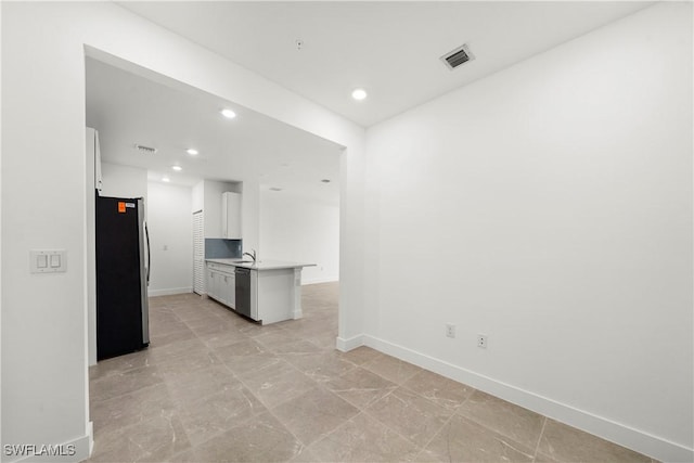 kitchen featuring sink, white cabinets, and stainless steel appliances