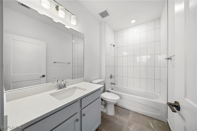 full bathroom with vanity, tiled shower / bath combo, and toilet