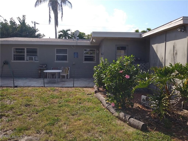 rear view of property with a patio area and a yard