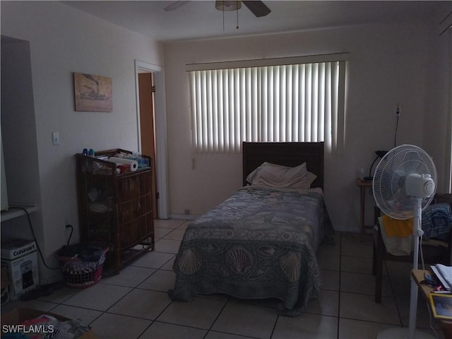 tiled bedroom featuring ceiling fan