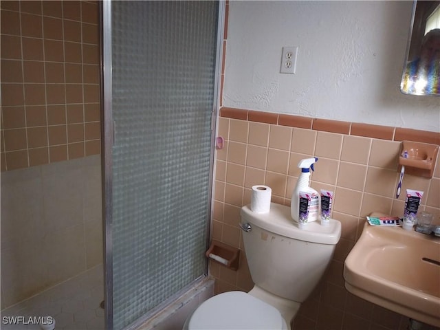 bathroom featuring toilet, walk in shower, and sink