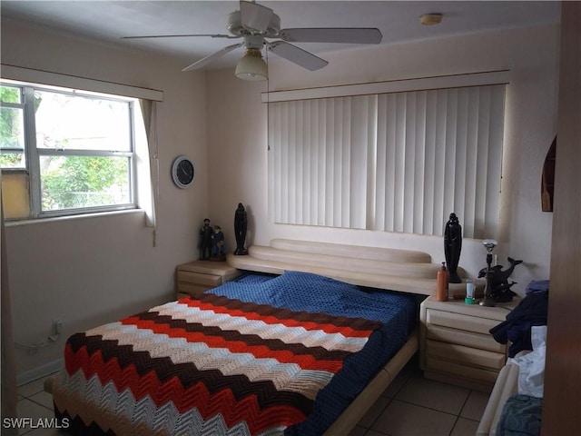 tiled bedroom featuring ceiling fan