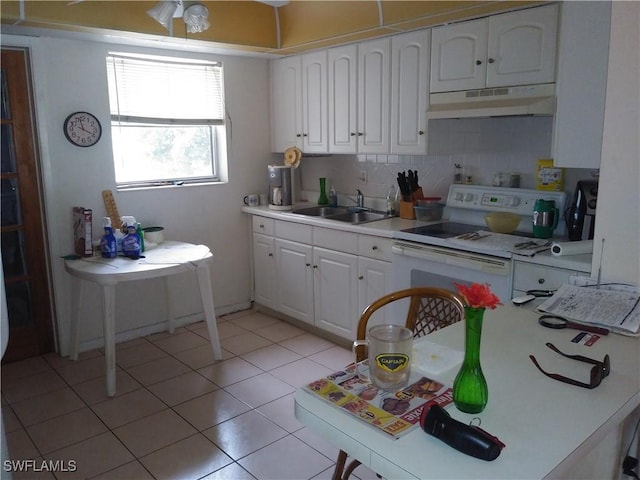 kitchen featuring tasteful backsplash, sink, electric range, white cabinetry, and light tile patterned flooring