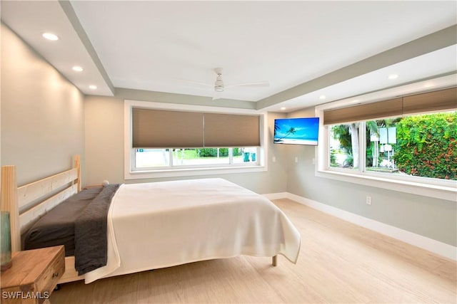 bedroom with multiple windows and ceiling fan