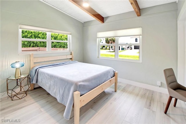 bedroom featuring lofted ceiling with beams, light hardwood / wood-style flooring, and wood ceiling