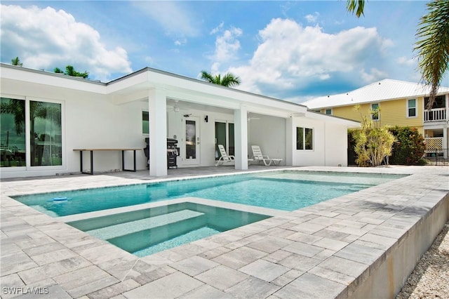 view of pool with grilling area, an in ground hot tub, ceiling fan, and a patio