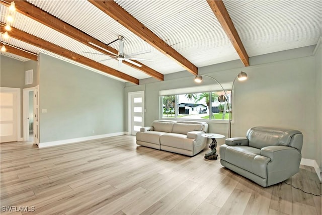 living room featuring lofted ceiling with beams, light hardwood / wood-style floors, and ceiling fan