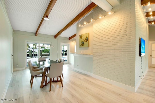 dining space featuring beamed ceiling, high vaulted ceiling, brick wall, and light hardwood / wood-style flooring