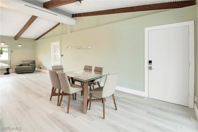 dining room featuring vaulted ceiling with beams and light hardwood / wood-style flooring