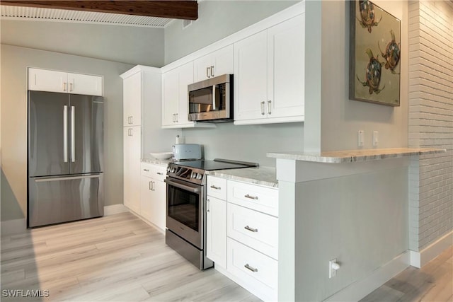 kitchen featuring kitchen peninsula, appliances with stainless steel finishes, light wood-type flooring, beamed ceiling, and white cabinetry