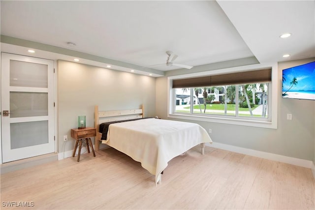 bedroom with ceiling fan and light hardwood / wood-style flooring