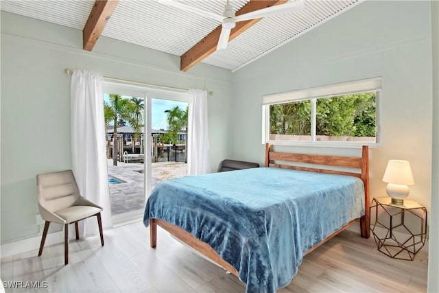 bedroom with access to outside, vaulted ceiling with beams, ceiling fan, and hardwood / wood-style flooring