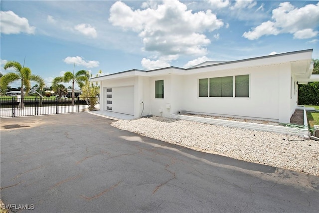 view of front of home featuring a garage and a water view