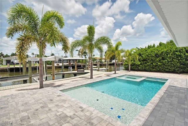 view of swimming pool with an in ground hot tub, a water view, a patio, and a boat dock