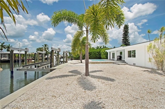 exterior space featuring a water view and a boat dock