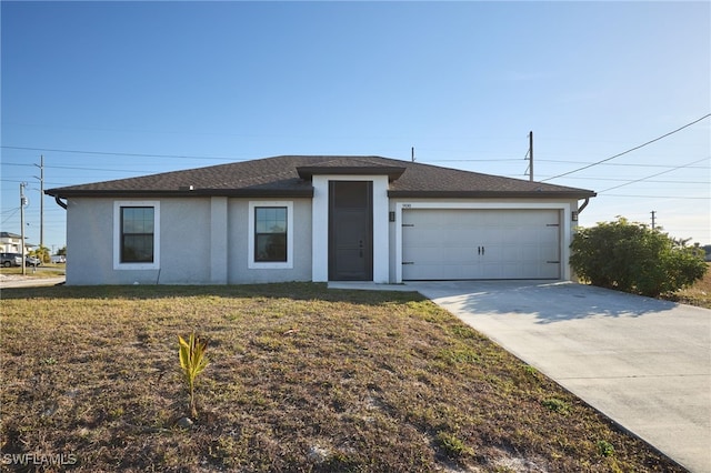 view of front facade featuring a garage and a front lawn