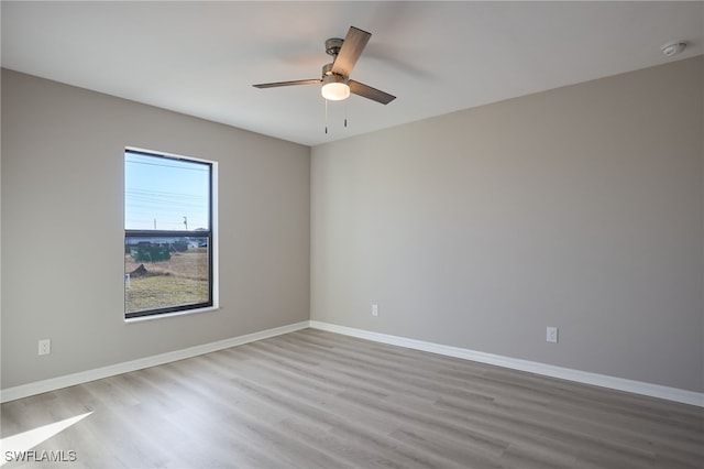 empty room featuring ceiling fan and light hardwood / wood-style floors