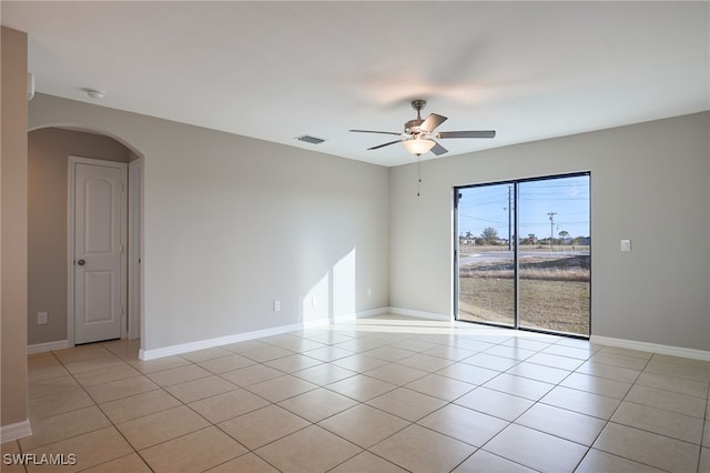 empty room with ceiling fan and light tile patterned flooring