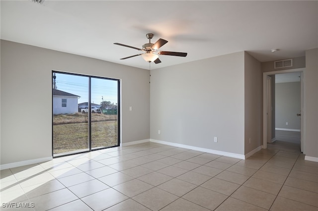 spare room with light tile patterned flooring and ceiling fan