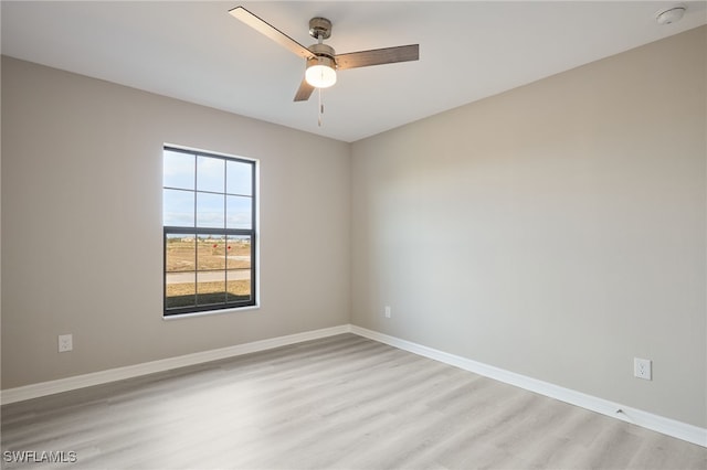 empty room featuring ceiling fan and light hardwood / wood-style flooring