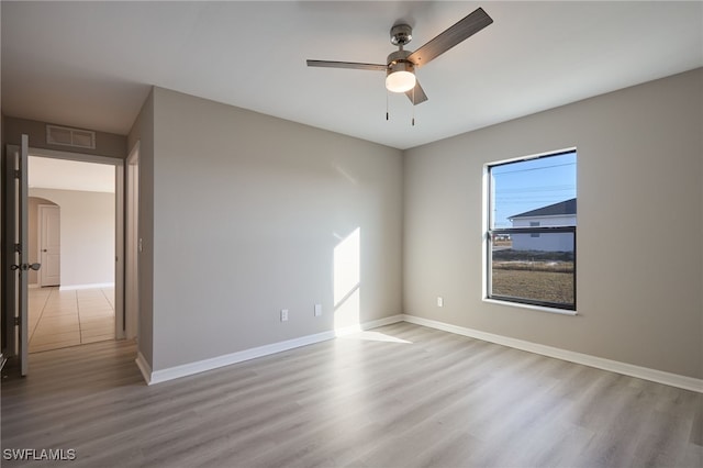 empty room with light hardwood / wood-style flooring and ceiling fan