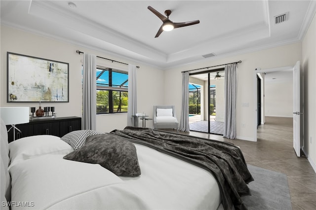 tiled bedroom with multiple windows, access to outside, and a tray ceiling