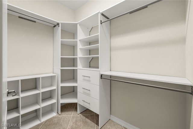 spacious closet featuring light tile patterned flooring