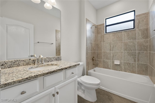 full bathroom featuring toilet, tile patterned flooring, vanity, and tiled shower / bath