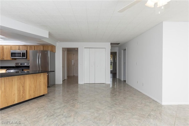 kitchen with ceiling fan and stainless steel appliances