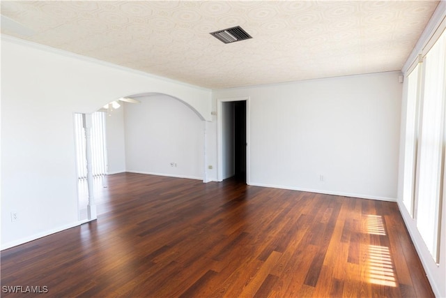 unfurnished room featuring a textured ceiling and dark hardwood / wood-style flooring