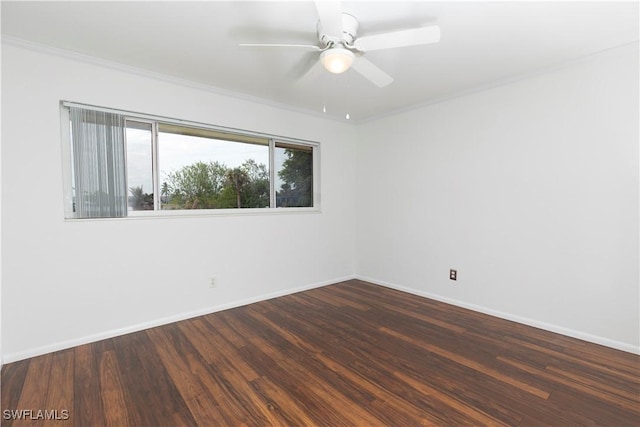 empty room with ceiling fan, dark hardwood / wood-style flooring, and crown molding