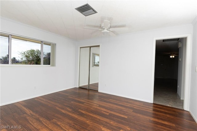 unfurnished room featuring ceiling fan, dark hardwood / wood-style floors, and crown molding