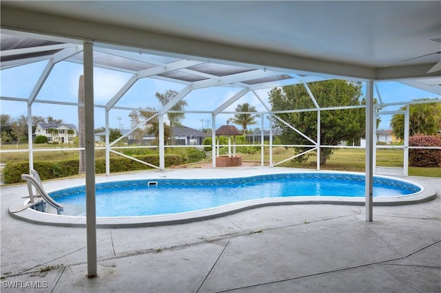 view of swimming pool featuring a lanai and a patio area