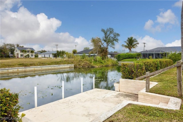 dock area featuring a water view and a yard