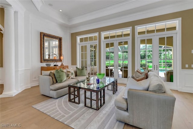 living room with french doors, light hardwood / wood-style floors, and crown molding