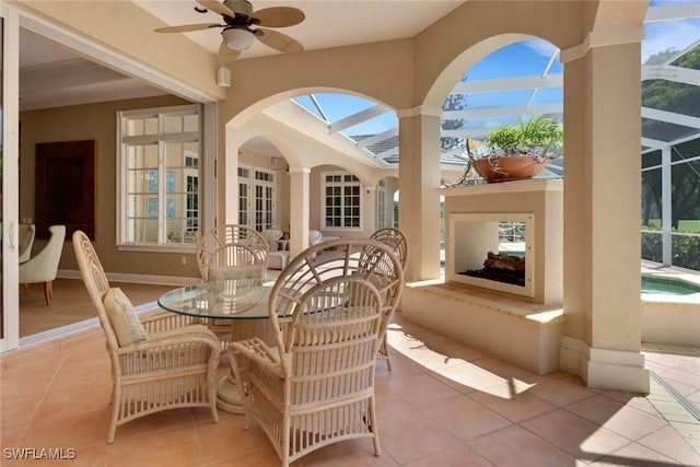 view of patio / terrace featuring a lanai, ceiling fan, and french doors