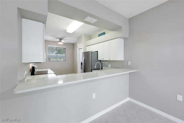 kitchen featuring ceiling fan, kitchen peninsula, sink, stainless steel fridge with ice dispenser, and white cabinets