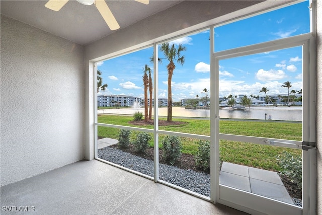 entryway with a water view and ceiling fan