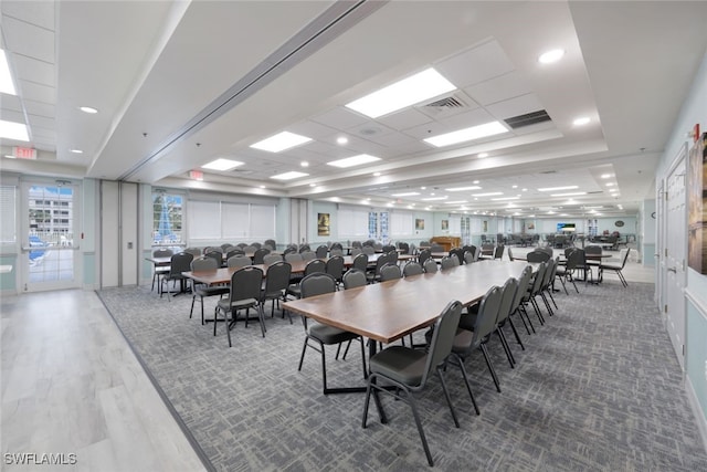 dining area featuring a tray ceiling and hardwood / wood-style floors