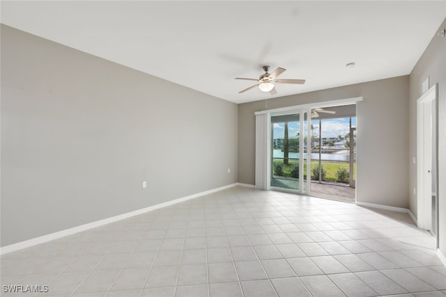 empty room featuring ceiling fan and light tile patterned floors