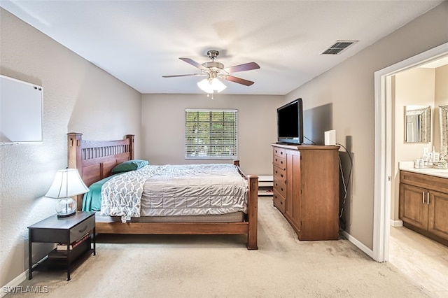 carpeted bedroom featuring ceiling fan and connected bathroom