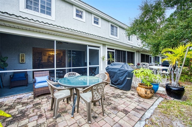 view of patio / terrace featuring a grill and a sunroom