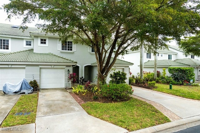 view of front of house featuring a front lawn and a garage