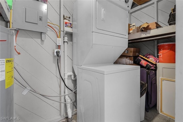 laundry room with electric panel and stacked washer and dryer