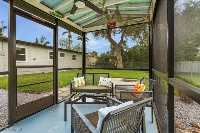 sunroom / solarium with ceiling fan and lofted ceiling