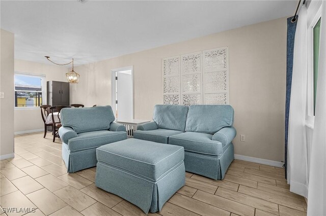 living room with light hardwood / wood-style floors and a chandelier