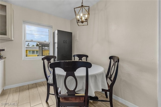 dining room with light hardwood / wood-style floors and a chandelier