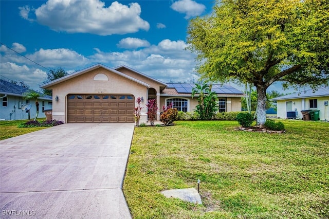 ranch-style home featuring a front yard, a garage, solar panels, and central AC unit