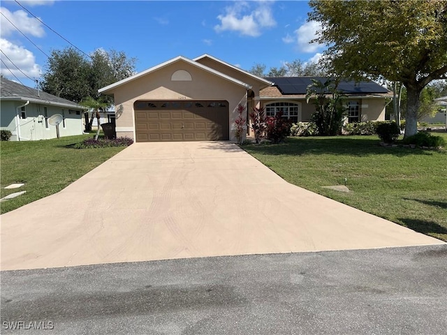 ranch-style house with a garage, a front lawn, and solar panels