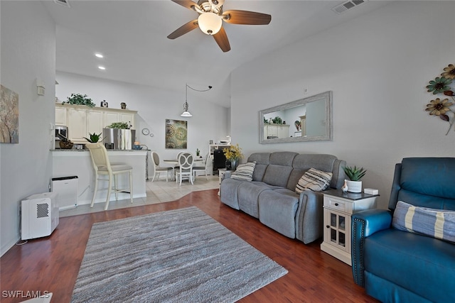 living room with ceiling fan and dark hardwood / wood-style floors